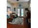 Living room with wicker chairs, a green couch, and hardwood floors at 458 Grant St, Dunedin, FL 34698