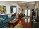 Living room with green couch, wicker chairs, and access to the pool at 458 Grant St, Dunedin, FL 34698