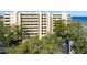 Aerial view of waterfront condo building with lush landscaping and parking at 5020 Bayshore Blvd # 403, Tampa, FL 33611