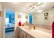Bright bathroom with double sinks, tiled floor, and a view into the bedroom at 5020 Bayshore Blvd # 403, Tampa, FL 33611