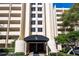 Condo building's main entrance with awning, landscaping, and American flag at 5020 Bayshore Blvd # 403, Tampa, FL 33611