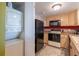 Condo kitchen with light wood cabinets and black appliances at 5020 Bayshore Blvd # 403, Tampa, FL 33611