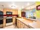 Condo kitchen with light wood cabinets and black appliances at 5020 Bayshore Blvd # 403, Tampa, FL 33611