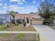 House exterior with nicely landscaped front yard at 630 Bayside Dr, Tarpon Springs, FL 34689