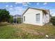 House exterior showcasing a side view, fenced yard, and mature landscaping at 630 Bayside Dr, Tarpon Springs, FL 34689