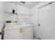 Laundry room with washer, dryer, and shelving at 630 Bayside Dr, Tarpon Springs, FL 34689