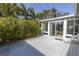 Relaxing patio area adjacent to a glass sunroom at 6390 115Th Ln, Seminole, FL 33772