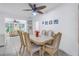 Bright dining room with light wood table and chairs, offering a view of the living room at 6390 115Th Ln, Seminole, FL 33772