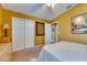 Bedroom with queen bed, ceiling fan, and mustard-colored walls at 6621 Gentle Ben Cir, Wesley Chapel, FL 33544