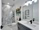 Modern bathroom with gray vanity and walk-in shower at 705 Pinckney Dr, Apollo Beach, FL 33572