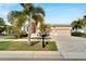 Beautiful home with palm trees, a paved driveway, and well-manicured lawn at 705 Pinckney Dr, Apollo Beach, FL 33572