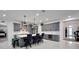 Spacious kitchen with an island, gray cabinets, and a marble backsplash at 705 Pinckney Dr, Apollo Beach, FL 33572