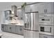 Modern kitchen with stainless steel appliances and gray cabinetry at 705 Pinckney Dr, Apollo Beach, FL 33572