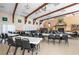 Large community hall with tables, chairs, and a fireplace at 7050 El Matador St, Zephyrhills, FL 33541