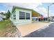 Front view of a light green mobile home at 7050 El Matador St, Zephyrhills, FL 33541