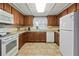 Bright kitchen, featuring wood cabinets and white appliances at 7050 El Matador St, Zephyrhills, FL 33541
