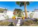 Relaxing courtyard with flowering plants, bench, and palm tree at 7050 El Matador St, Zephyrhills, FL 33541