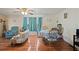 Living room with floral couch and wood flooring at 7050 El Matador St, Zephyrhills, FL 33541