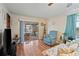 Bright living room features wood floors and sliding glass doors leading to a screened porch at 7050 El Matador St, Zephyrhills, FL 33541