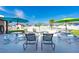 Pool area with tables, chairs, and umbrellas at 7050 El Matador St, Zephyrhills, FL 33541