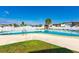 Community pool with surrounding lawn at 7050 El Matador St, Zephyrhills, FL 33541