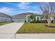 House exterior, two-story home with green exterior, landscaping, and driveway at 8017 112Th E Ave, Parrish, FL 34219