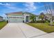 Two-story house with green exterior, landscaping, and driveway at 8017 112Th E Ave, Parrish, FL 34219