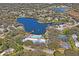 Aerial view of community with lake, pool, and tennis courts at 8130 Merrimac Dr, Port Richey, FL 34668