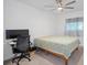 Bedroom with home office setup and ceiling fan at 8130 Merrimac Dr, Port Richey, FL 34668