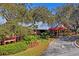 Timber Oaks Clubhouse with lush landscaping at 8130 Merrimac Dr, Port Richey, FL 34668