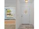 Bright entryway with window seat and white door at 8130 Merrimac Dr, Port Richey, FL 34668