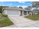 Ranch home with a screened garage and a large driveway at 8130 Merrimac Dr, Port Richey, FL 34668