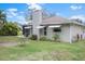 View of the house's exterior, showcasing its light gray walls and roof at 8130 Merrimac Dr, Port Richey, FL 34668