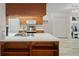 Modern kitchen with wood cabinets, stainless steel appliances, and white countertops at 8130 Merrimac Dr, Port Richey, FL 34668