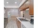 Modern kitchen with wood cabinets, stainless steel appliances, and white countertops at 8130 Merrimac Dr, Port Richey, FL 34668