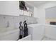 Laundry room with washer, dryer, and utility sink at 8130 Merrimac Dr, Port Richey, FL 34668