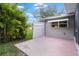 Pink patio area with privacy screen and lush landscaping at 8130 Merrimac Dr, Port Richey, FL 34668