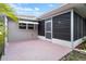 Patio area with screened enclosure and landscaping at 8130 Merrimac Dr, Port Richey, FL 34668