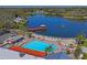 Community pool area with lake view and lounge chairs at 8130 Merrimac Dr, Port Richey, FL 34668