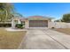 Single-story home with attached garage and landscaped yard at 8382 Windridge Way, Weeki Wachee, FL 34613