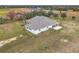 Aerial view of house, detached garage, and large backyard at 8459 Harvey Walden Dr, Plant City, FL 33565