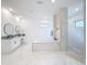 Luxurious bathroom featuring a soaking tub and walk-in shower at 8459 Harvey Walden Dr, Plant City, FL 33565