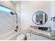 Modern bathroom with marble tile, a large vanity, and a walk-in shower at 8459 Harvey Walden Dr, Plant City, FL 33565