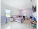 Bright bedroom with purple walls and a comfy bed at 8459 Harvey Walden Dr, Plant City, FL 33565