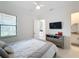Well-lit bedroom with a queen bed and private bathroom access at 8459 Harvey Walden Dr, Plant City, FL 33565