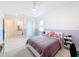 Spacious bedroom with ensuite bathroom and a ceiling fan at 8459 Harvey Walden Dr, Plant City, FL 33565