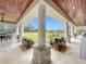 Covered patio with stone pillars and view of the backyard at 8459 Harvey Walden Dr, Plant City, FL 33565