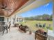 Covered patio with seating area and view of the backyard at 8459 Harvey Walden Dr, Plant City, FL 33565