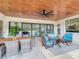 Spacious covered patio featuring comfortable seating and a dining area at 8459 Harvey Walden Dr, Plant City, FL 33565