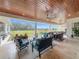 Large covered patio with seating and dining areas and a beautiful view at 8459 Harvey Walden Dr, Plant City, FL 33565